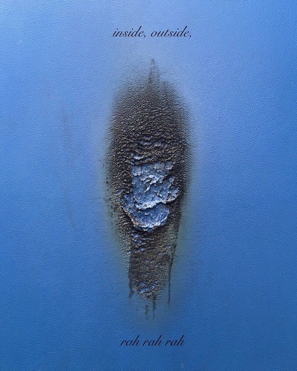 blue plastic burnt in the middle with superimposed text reading 'inside, outside ... rah, rah, rah' 